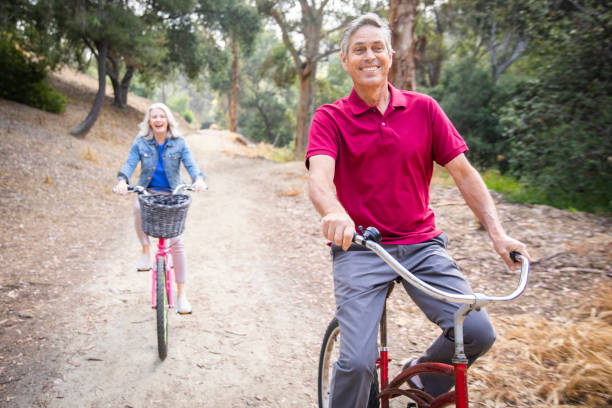 istock Senior Couple Riding Bicycles in Nature 1146964337