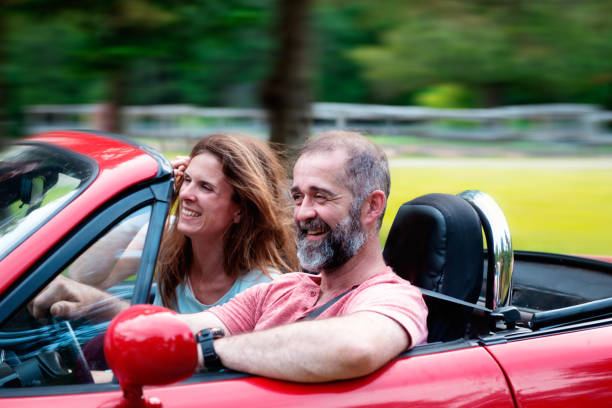 Happy Couple in a convertible red car