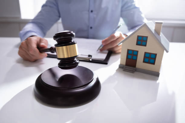 istock Judge With House Model Hitting Gavel 1146964381