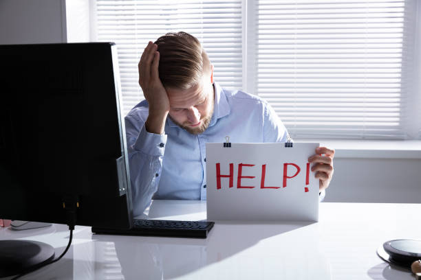 istock Businessman Holding Cardboard With Help Text 1146964953