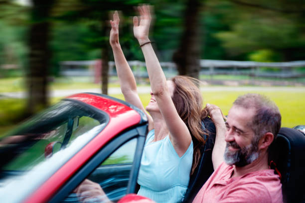 istock Happy Couple in a convertible red car 1146964967