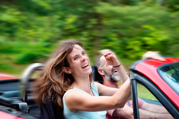 istock Happy Couple in a convertible red car 1146965039