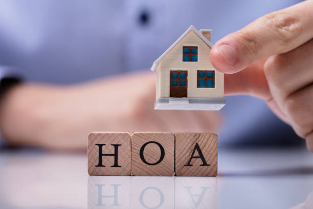 istock Businessman Placing House Models On HOA Cubic Blocks 1146965456