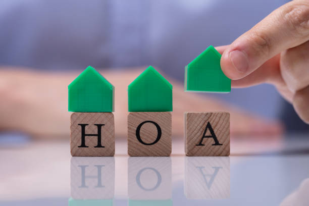 istock Businessman Placing House Models On HOA Cubic Blocks 1146965462