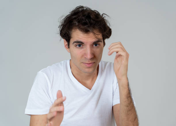 istock Portrait of Handsome latin young man in shock with a scared expression on his face making frightened and defence gestures in human emotions feelings and facial expression. Studio shot. 1146965504