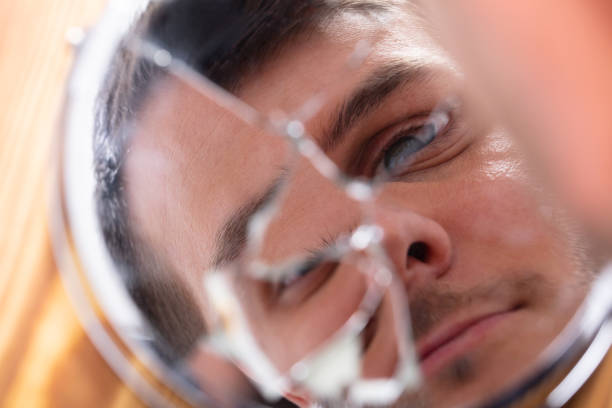 istock Reflection Of A Man's Face In Broken Mirror 1146967186