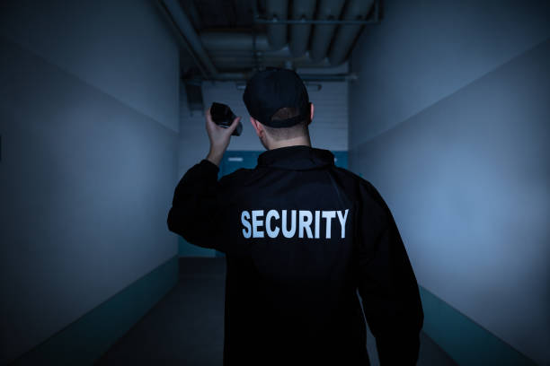 istock Male Security Guard Standing In Corridor 1146967898