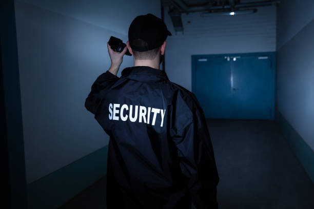 istock Male Security Guard Standing In Corridor 1146967909
