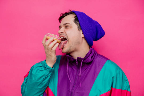istock Young man in 90s clothes with sweet donut 1146970800