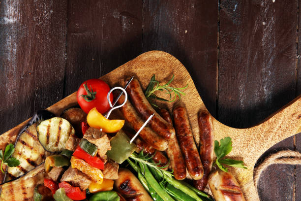 istock Assorted delicious grilled meat with vegetable on a barbecue. Grilled pork shish or kebab on skewers with vegetables . Food background shashlik 1146971221