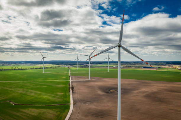 istock White wind turbines in a brown field, aerial view 1146973278