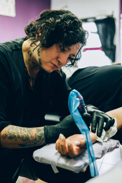 istock Tattoo artist working in his studio 1146973426