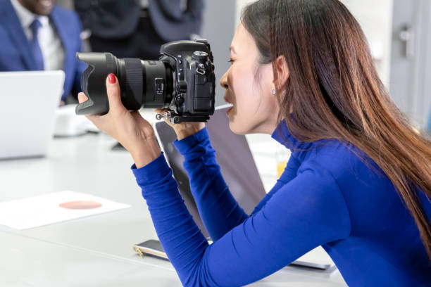 istock Woman trying to use professional camera 1146974055