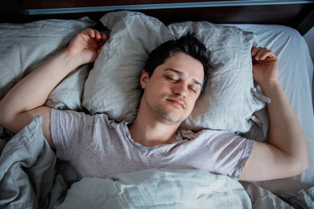 istock Yound man sleep in a bed at home. 1146975202