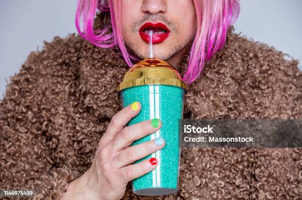 Transvestite Man With Lipstick And Polish Nail Holding Cocktail Stock Photo - Download Image Now