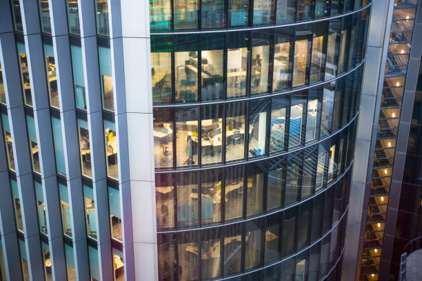 Office windows of City of london buildings at night. London, UK London, UK - 25 April, 2019: Office windows of City of london buildings at night office window night stock pictures, royalty-free photos & images