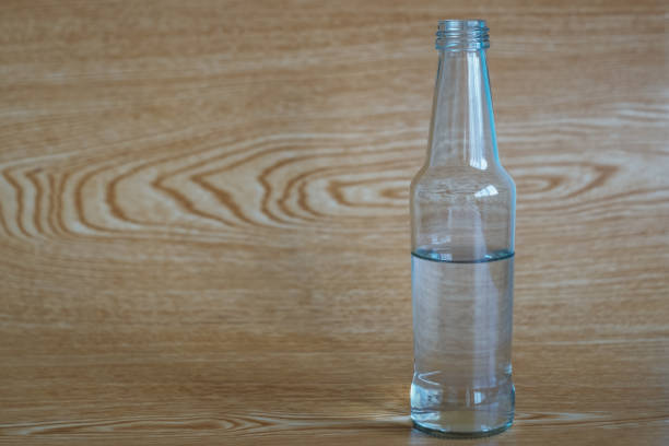 istock Glass bottle with water and wood pattern background 1146982710