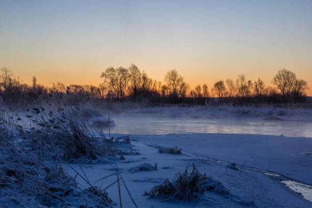 Dawn on the river Usva, Russia. Frosty morning on the river, winter. Snow on the banks of the river, dense forest Dawn on the river Usva, Russia. Frosty morning on the river, winter. Snow on the banks of the river, dense forest. Morning dawn on the river in a strong frost. On a thermometer 31 cold frozen river stock pictures, royalty-free photos & images