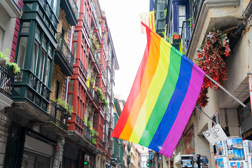 view of rainbow flag in historical downtown street of Bilbao, Spain