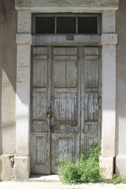 istock Old wooden front door in stone wall 1146986083