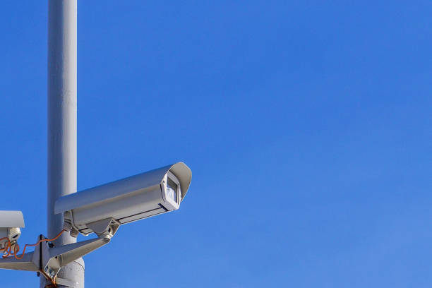 istock Security camera against the blue sky are monitoring. 1146986890