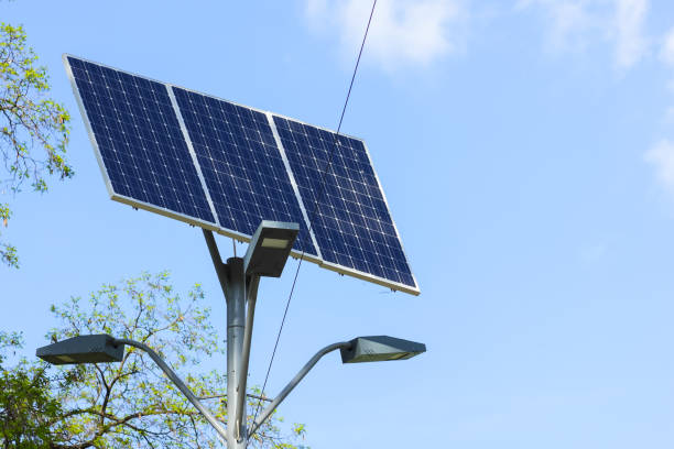 istock Solar cell lamp on sky background. Light support with lantern and installed solar panels on blue sky. Alternative energy from the sun 1146991298