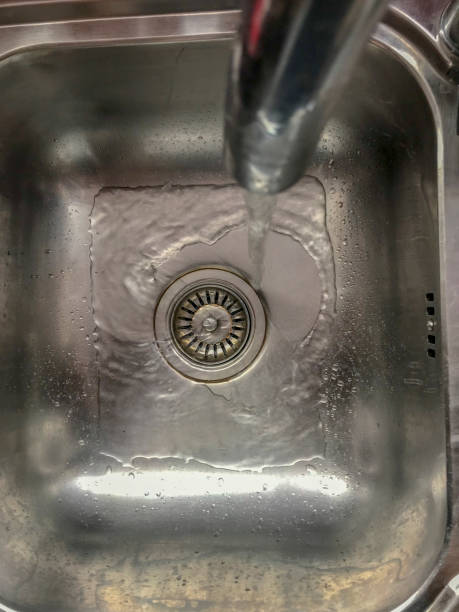 istock Running water from tap in steel sink 1146993138