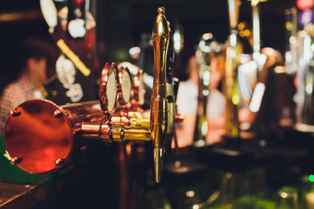 istock Barman hands pouring a lager beer in a glass. 1146996484