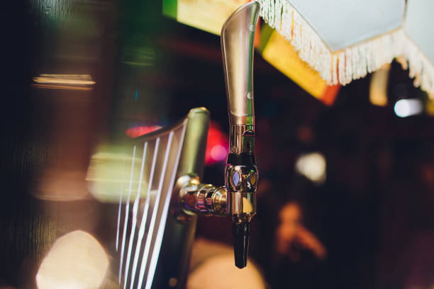 istock Barman hands pouring a lager beer in a glass. 1146996496