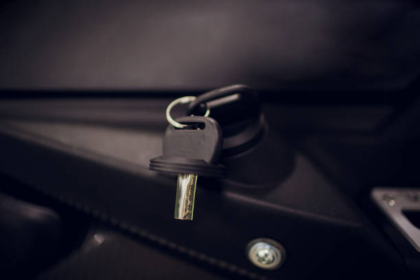 istock Ignition key modern car close up. Car atv key in keyhole 1146999215