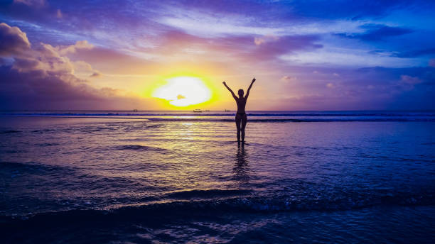 istock Beautiful girl on sunset background on sandy beach 1147001152
