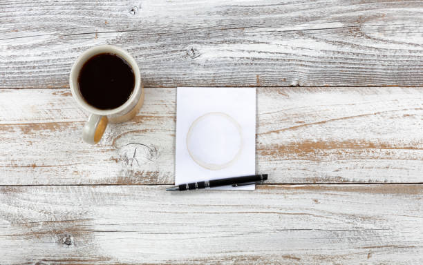istock Top view of desktop with writing materials plus morning coffee on desktop 1147001235