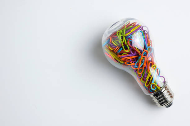 istock Light bulb filled with colorful paper clips 1147002492