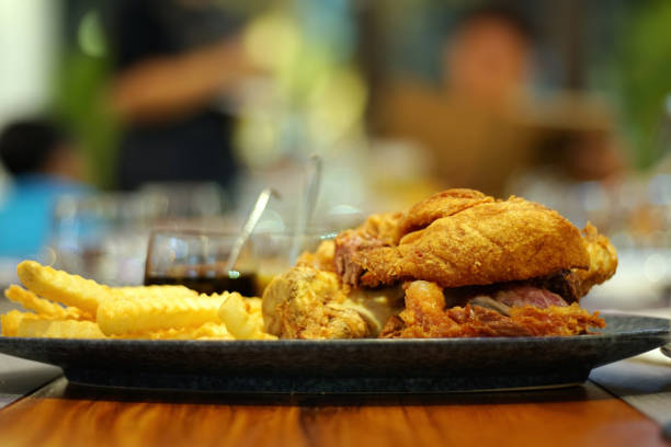 close up of hand sliding german pork knuckle on the table in restaurant at night party. good view of pub & restaurant concept. - shank sauerkraut german cuisine pork imagens e fotografias de stock