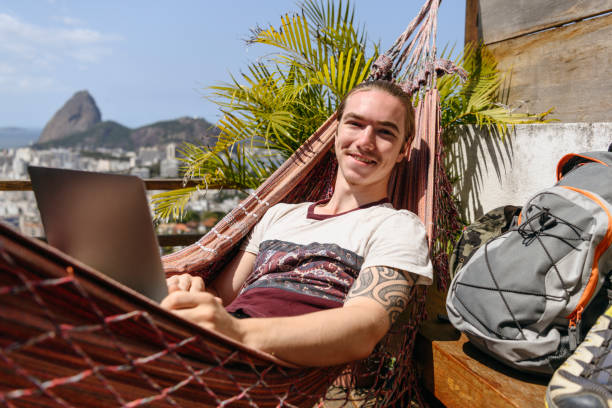 istock Portrait of young man in hammock smiling 1147004217