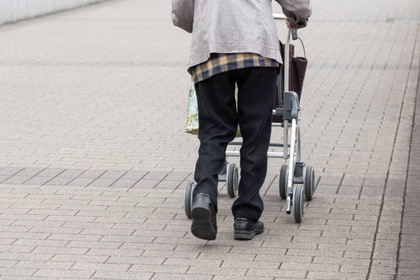 istock Elderly person with walking auxiliary instrument. 1147007927
