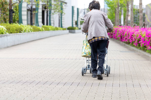 istock Elderly person with walking auxiliary instrument. 1147007957