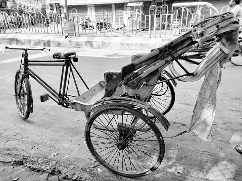 Jhargram, West Bengal, India - May 05, 2019: Black and white image of A empty hand pulled rickshwa on a road of a city in West Bengal.