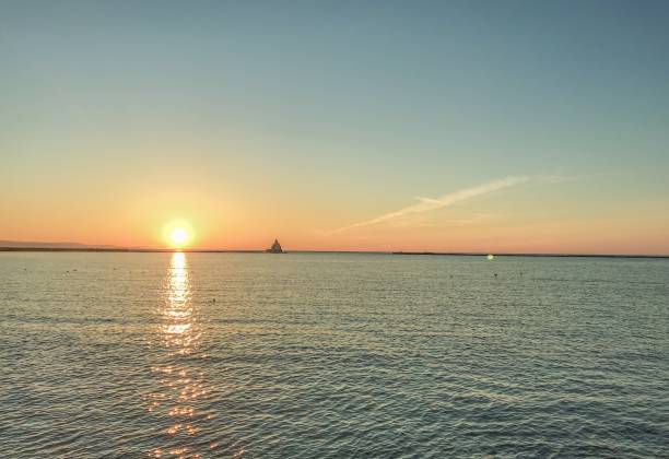 istock Sunrise Over Lake Michigan With Lighthouse 1147019720