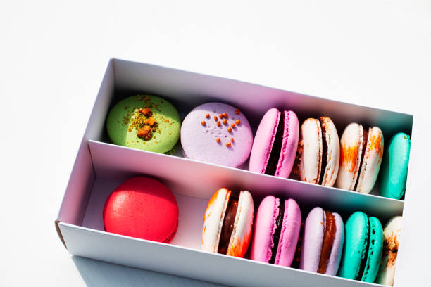 istock Tasty different colored macarons in white box on light background 1147020735
