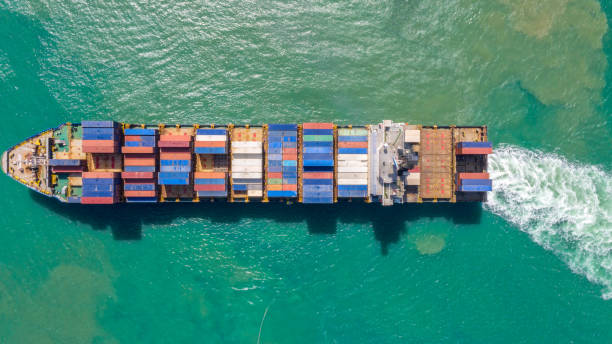 istock Container ship in export and import business logistics and transportation. Cargo and container box shipping to harbor by crane. Water transport International. Aerial view and top view. 1147021432