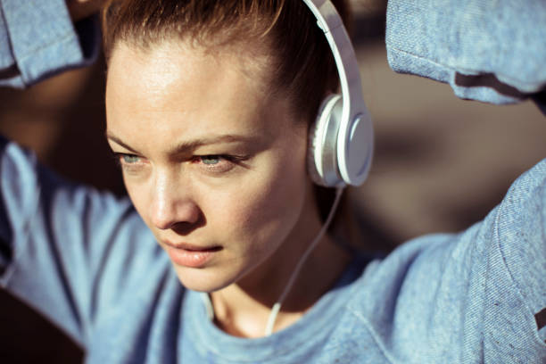 Getting Ready Close up of a woman tying her hair before jogging woman tying hair in ponytail getting ready for exercising stock pictures, royalty-free photos & images