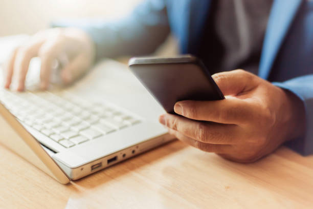 istock businessman use laptop and smartphone for work hard. 1147024338