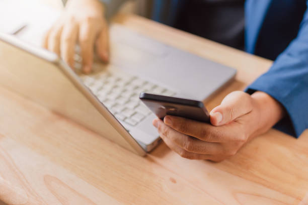 istock businessman use laptop and smartphone for work hard. 1147024341