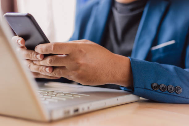 istock businessman use laptop and smartphone for work hard. 1147024348