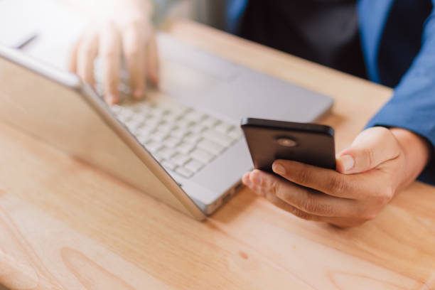 istock businessman use laptop and smartphone for work hard. 1147024389