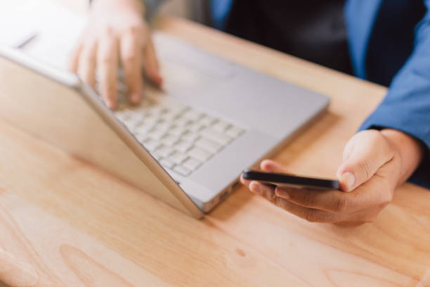 istock businessman use laptop and smartphone for work hard. 1147024391