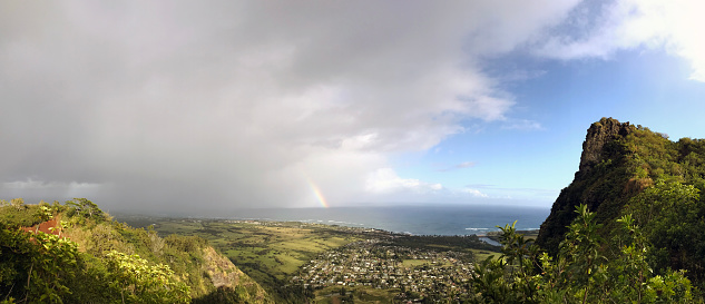 Rainbow and view of Kappa and east coastline seen from peak of Sleeping Giant, island of Kauai, Hawaii.