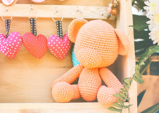 Lovely crocheting or kniting, orange bear nad mini heart key for romantic valentine background