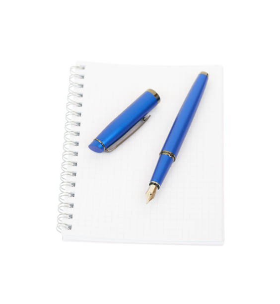 istock Fountain pen and spiral notebook isolated on white background. 1147029884